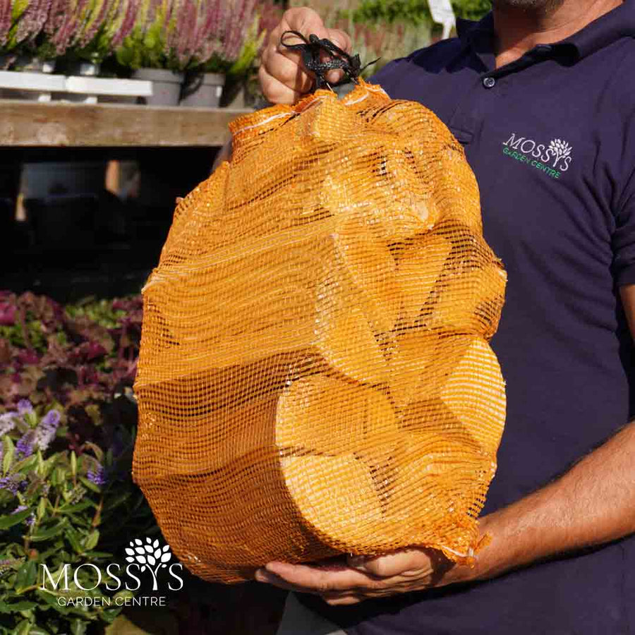 Man holding kiln dried hardwood log net at Mossys Garden Centre