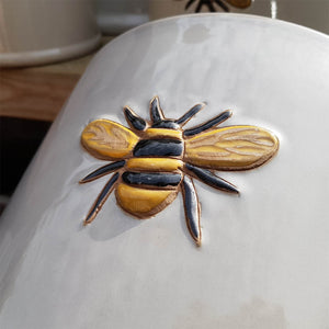 Bee kind bee pot emblem on side of pot